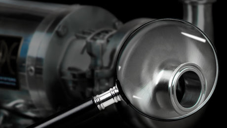 A magnifying glass hovering over a brew pump.